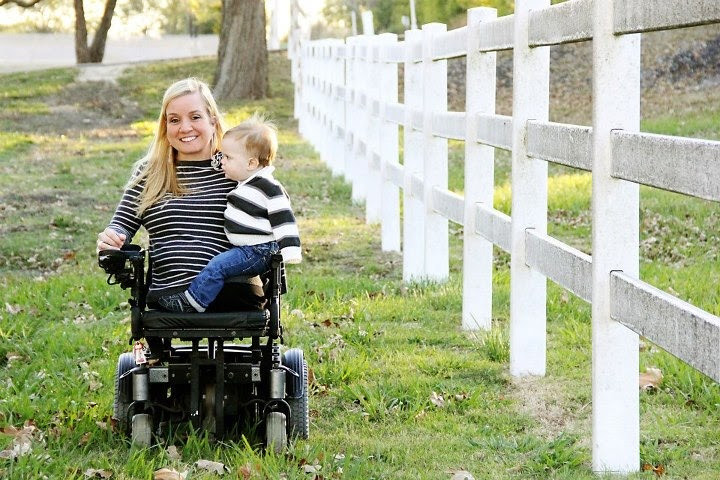 Erin Andrews in a wheelchair with a child on her lap. 