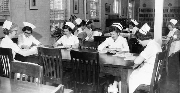 Faculty members and students at work in McKim Hall library, c. 1958.	Eleanor Crowder Bjoring Center for Nursing Historical Inquiry, University of Virginia School of Nursing. Ralph Thompson, Photographer.