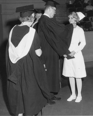 A 1966 diploma graduate proudly receives her School of Nursing pin.	Eleanor Crowder Bjoring Center for Nursing Historical Inquiry, University of Virginia School of Nursing.