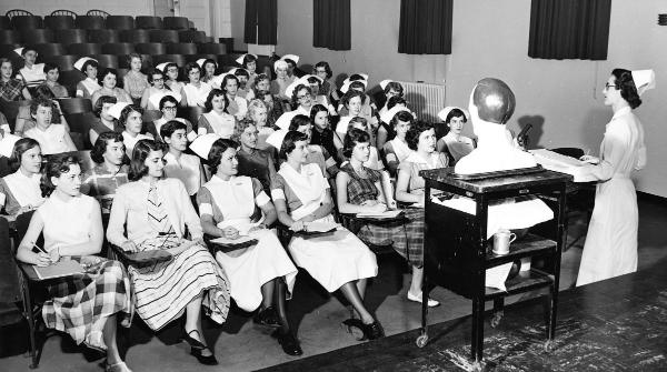 Vivian White instructs a 1954 class in McKim Hall auditorium.	Eleanor Crowder Bjoring Center for Nursing Historical Inquiry, University of Virginia School of Nursing.