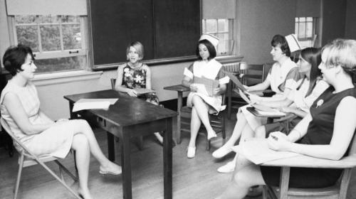 Faculty member and students in McKim basement classroom discussion, c. 1967.	Eleanor Crowder Bjoring Center for Nursing Historical Inquiry, University of Virginia School of Nursing.