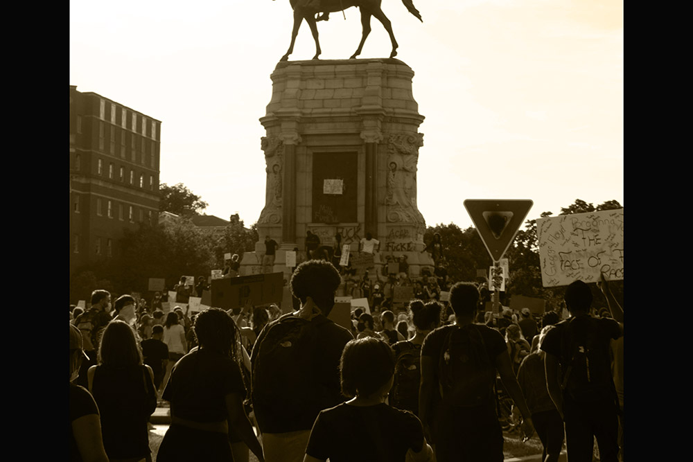 An image of the Robert E. Lee statue in Richmond, VA., amid Black Lives Matter marchers.