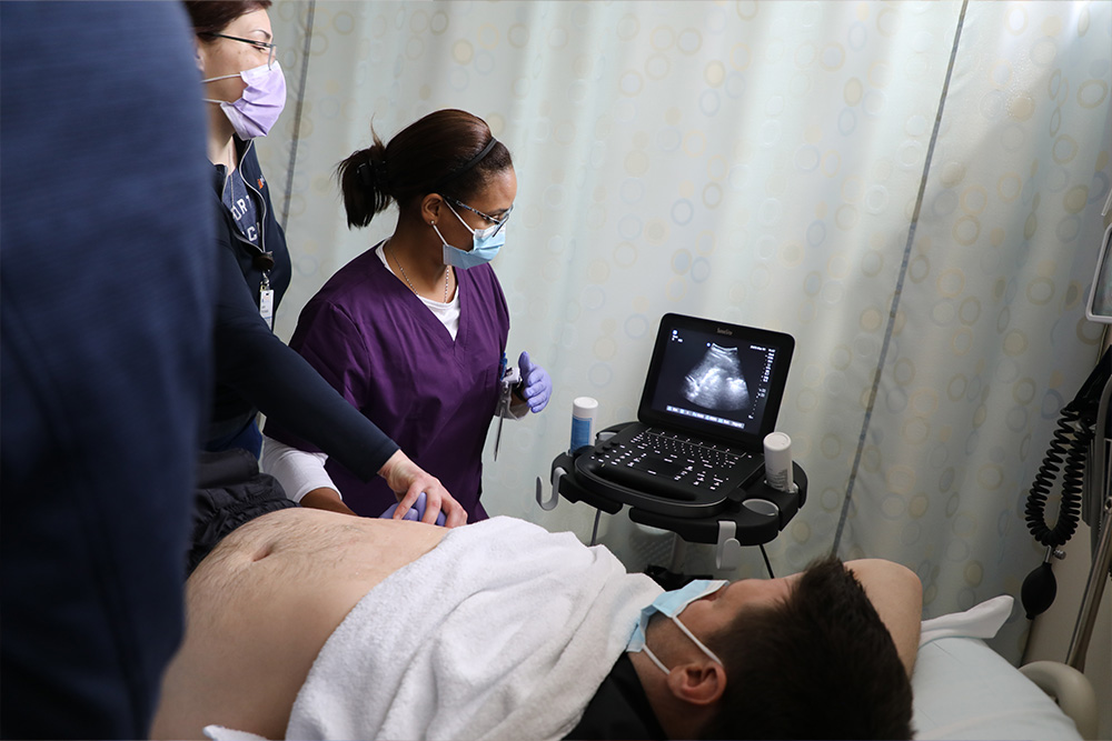 APRN students learning ultrasound in the SIM lab.