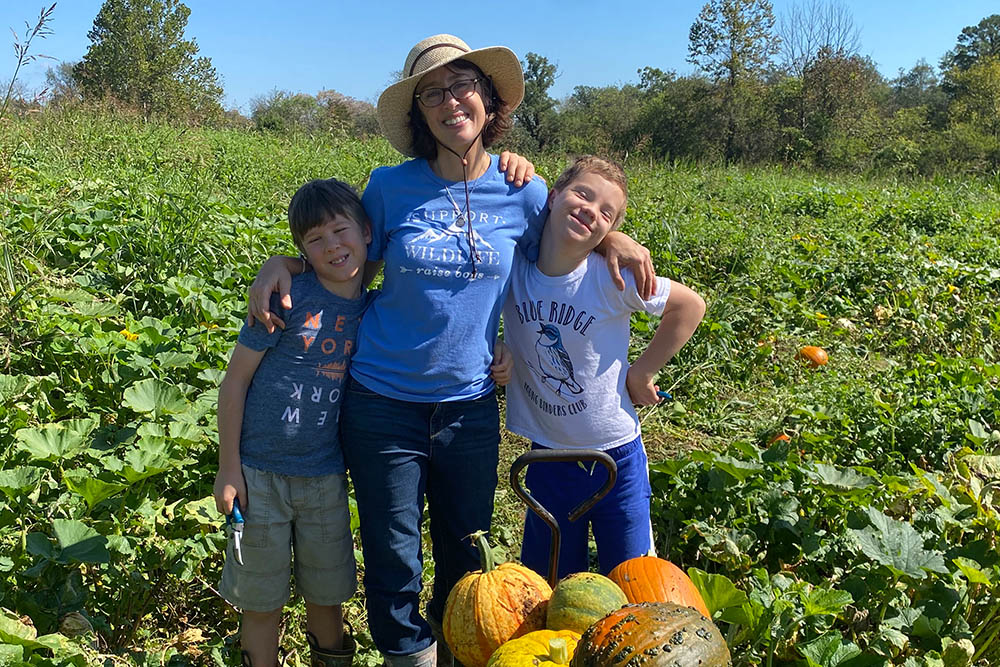 RN to BSN student and neurology nurse Christina Salidis in her garden with sons