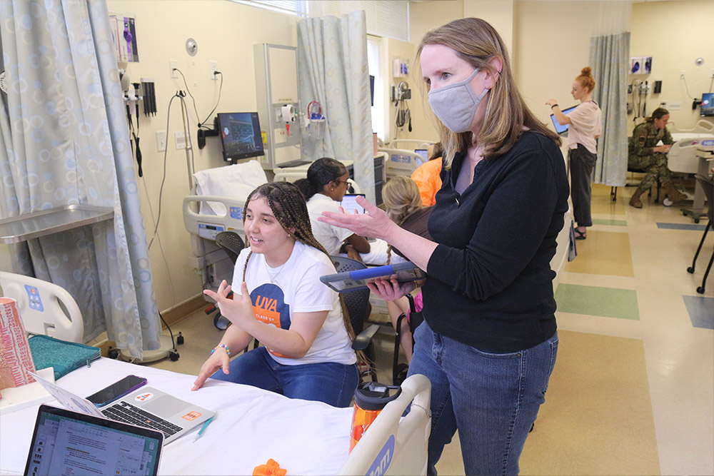 Christine Connelly and students work in the sim lab
