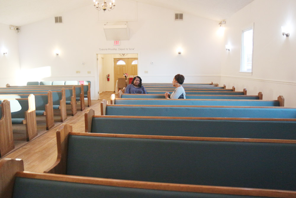Mrs. Wendi Cooper and Prof. Ishan Williams share a moment at Cooper's Pilgrim Baptist Church in Charlottesville.