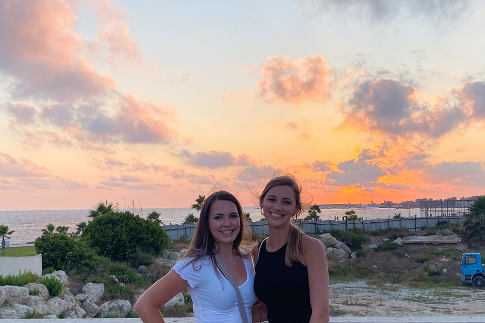 Kelly Murray and Allison Davis before a sunset in Cyprus.