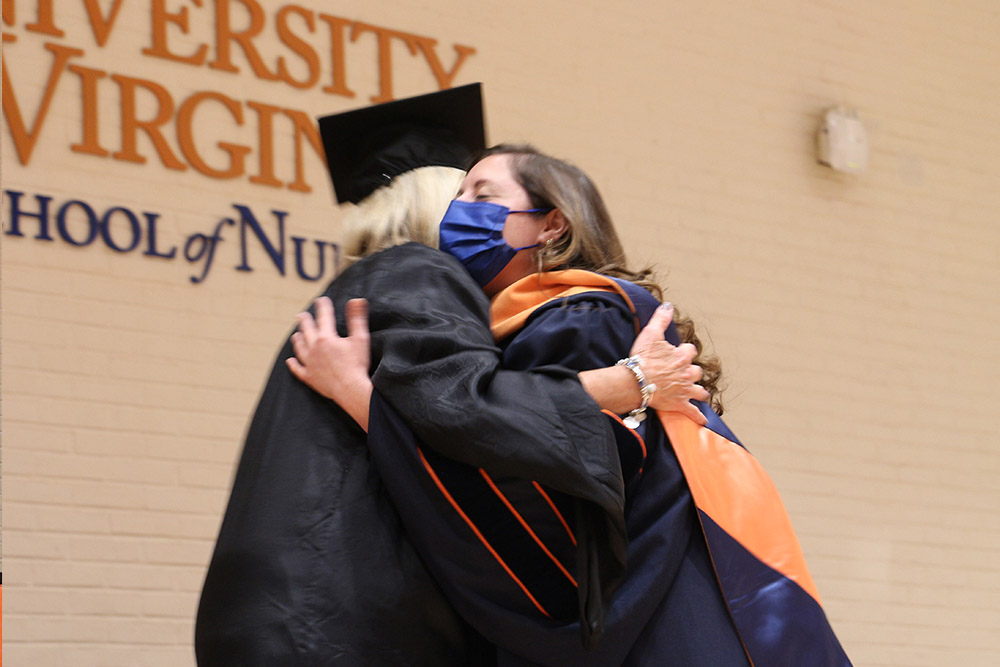 DNP graduate Larissa Rodriguez gets a hug from advisor mentor Clareen Wiencek.