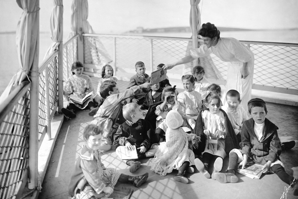 A nurse tending ill children on Tufts Floating Hospital who are spending a day at sea to get fresh air.