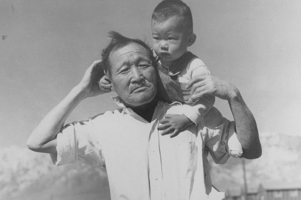 Japanese grandfather and grandson in Mananzar War Relocation Center, California.