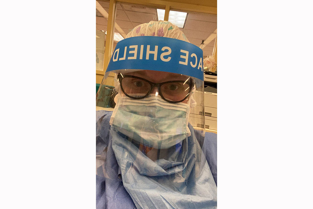 Heather Lister, BSN 2015, in the public hospital in Brooklyn, NY, where she works in a face mask.