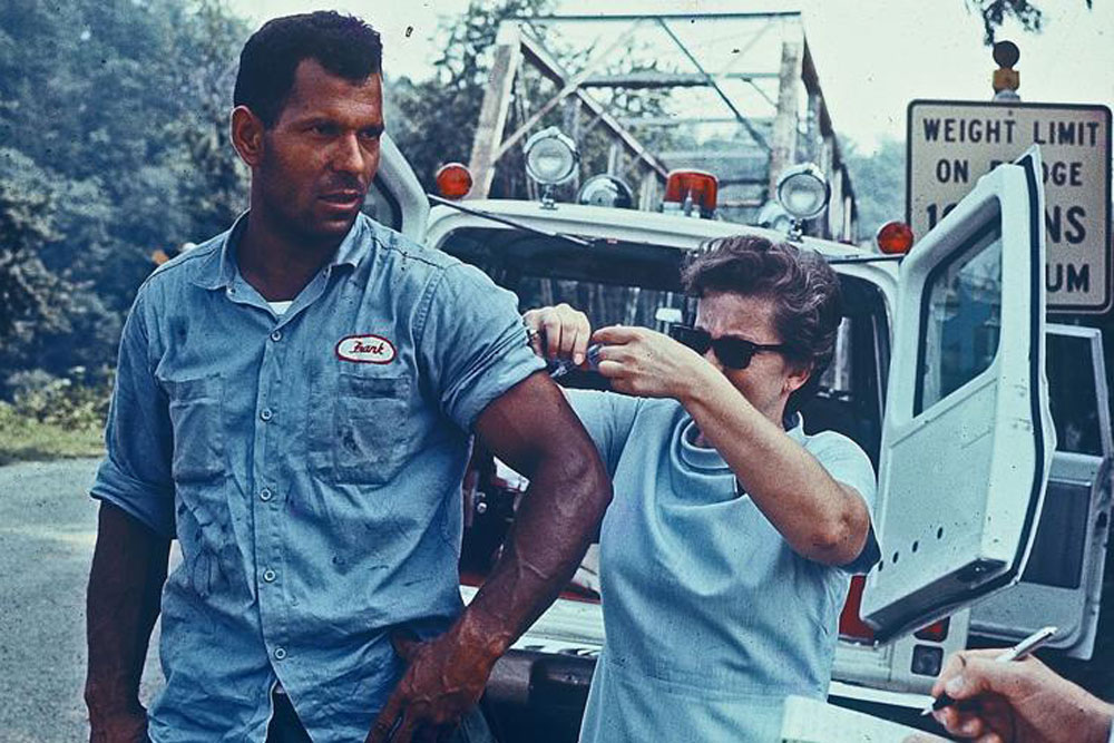 Public health nurse administers a typhoid shot after Hurrican Camille 1969