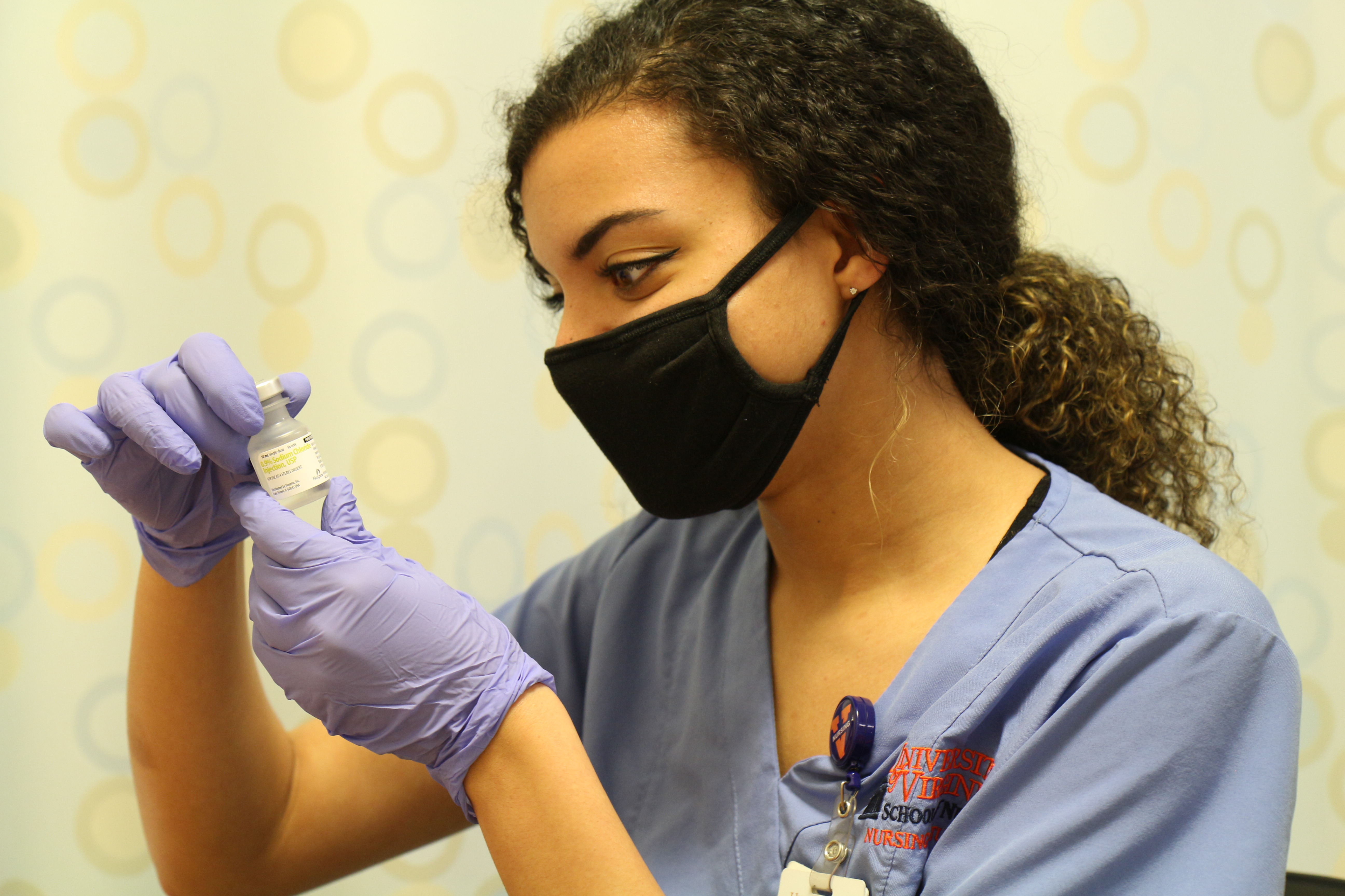 A nursing student preparing an injection