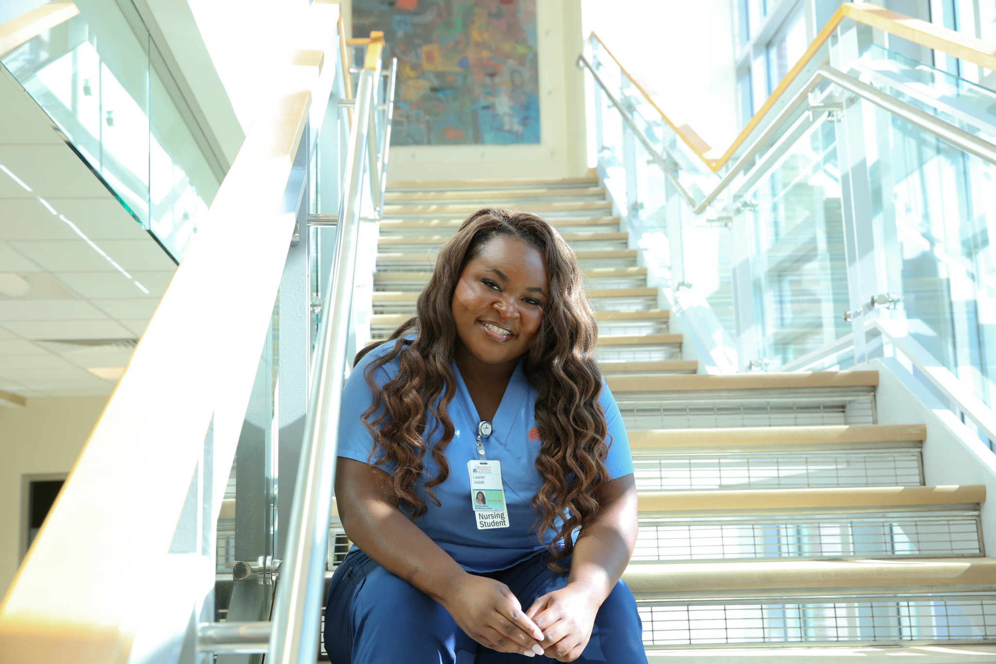 BSN Student, Lauren Josiah, sits on the stairs at the nursing school