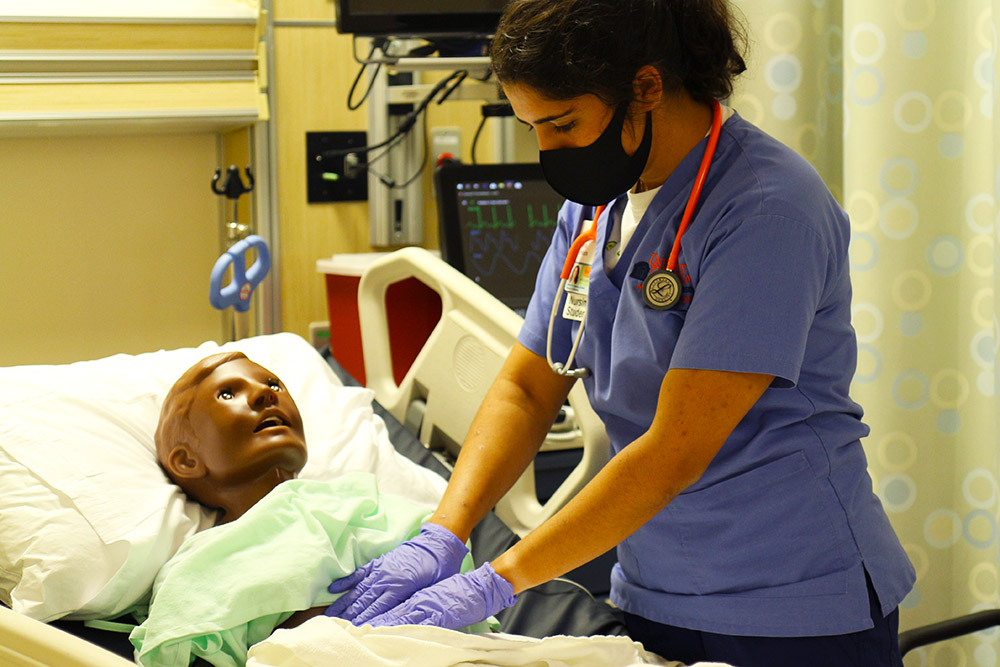A CNL student practices caring for a patient with sickle cell anemia experiencing pain.
