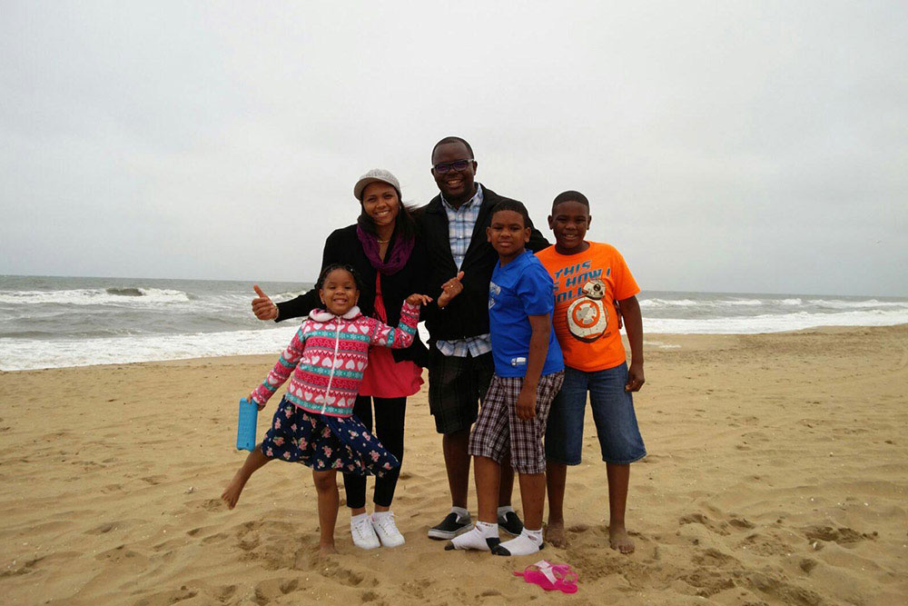 UVA Nursing CNL Class of 2020 Lucie Ndaya and Paterson Llunga at beach with their children