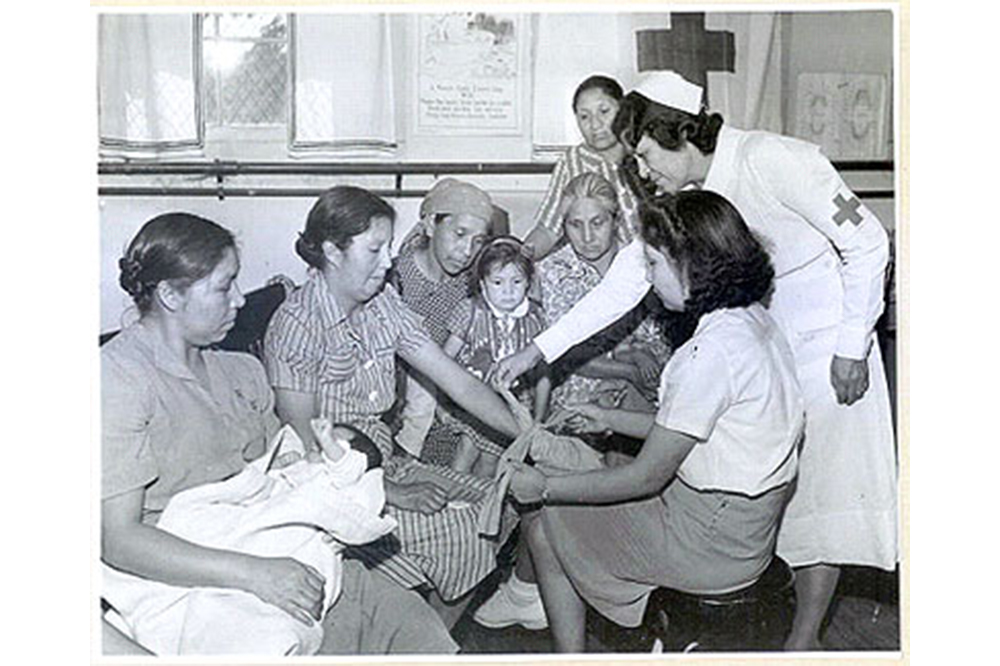 Nurse Lula Owl instructs women in first aid