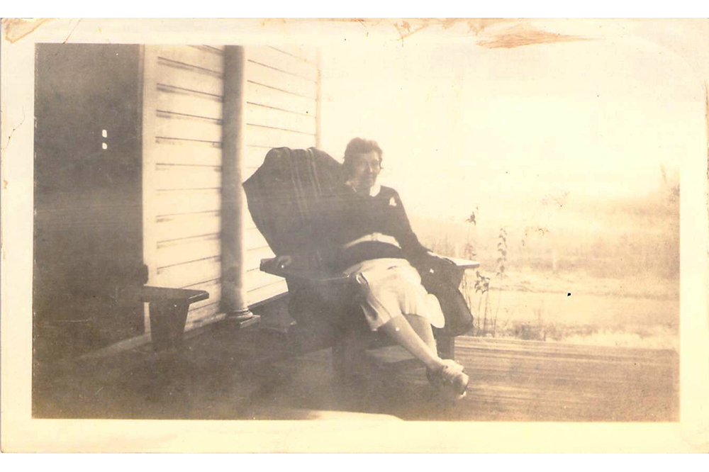 Nurse Lula Owl rests on a porch rocker in 1934