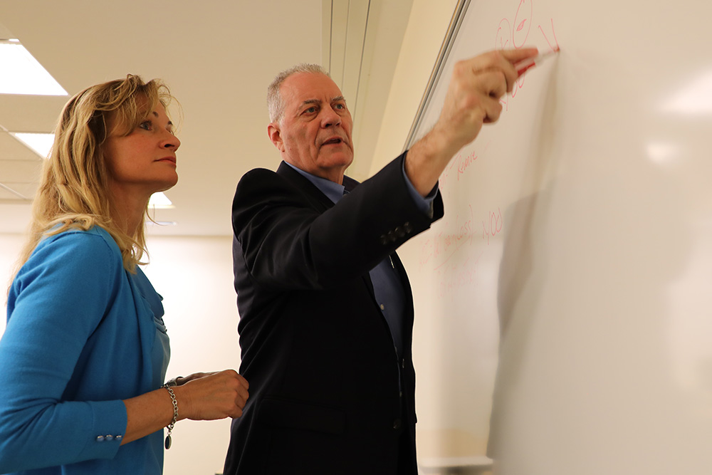 Professors Beth Quatrara and Richard Ridge teach grad students finance and business concepts.