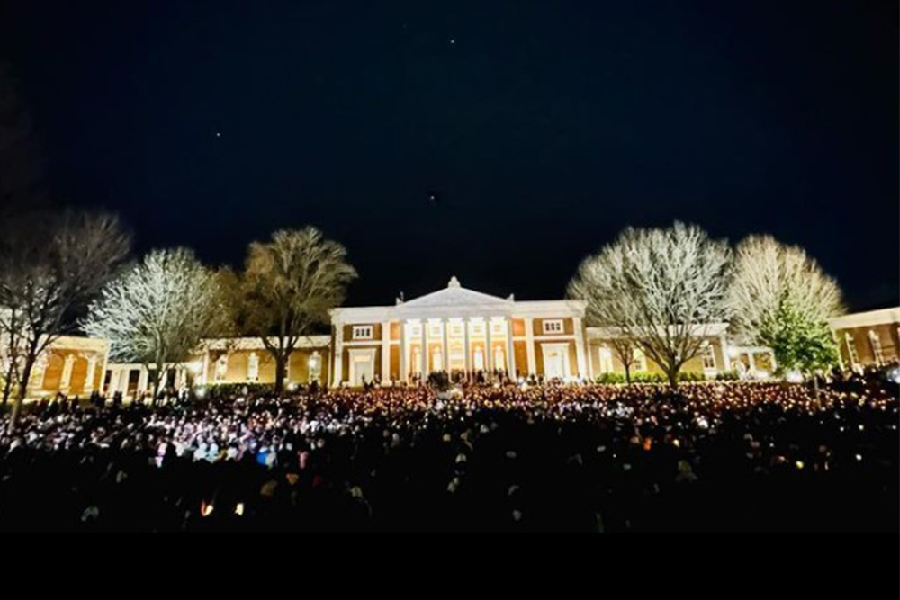 An image of Old Cabell Hall and a candlelight vigil on the UVA Lawn.