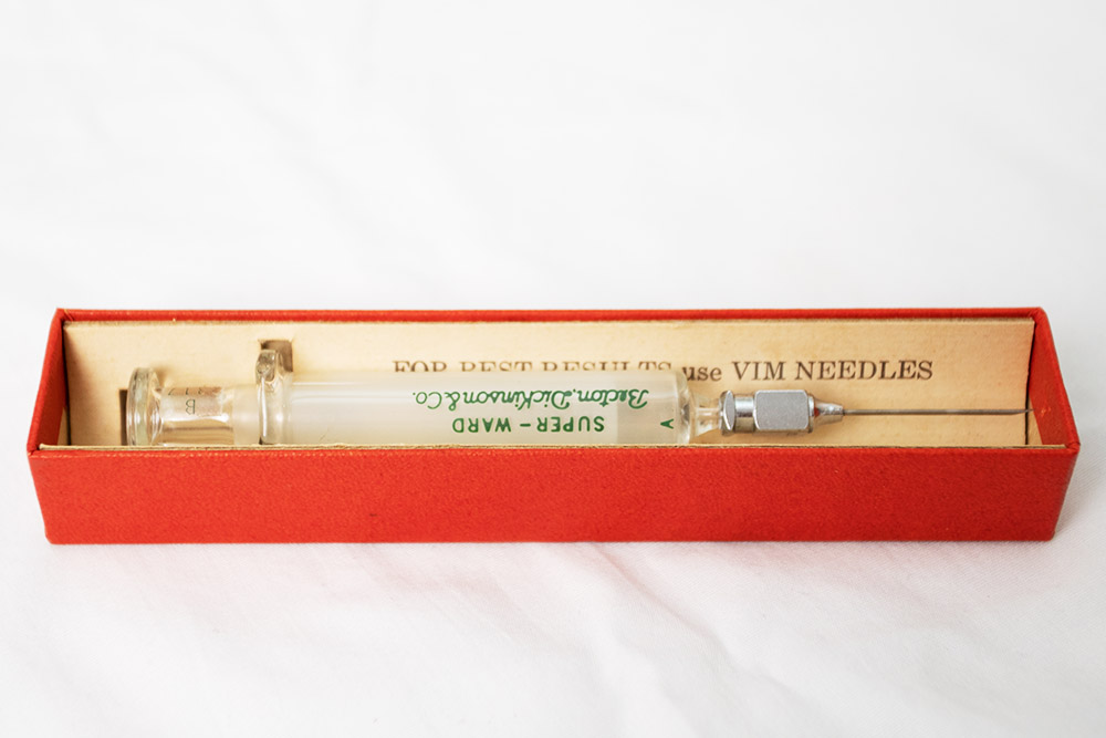 An old glass syringe and needle.