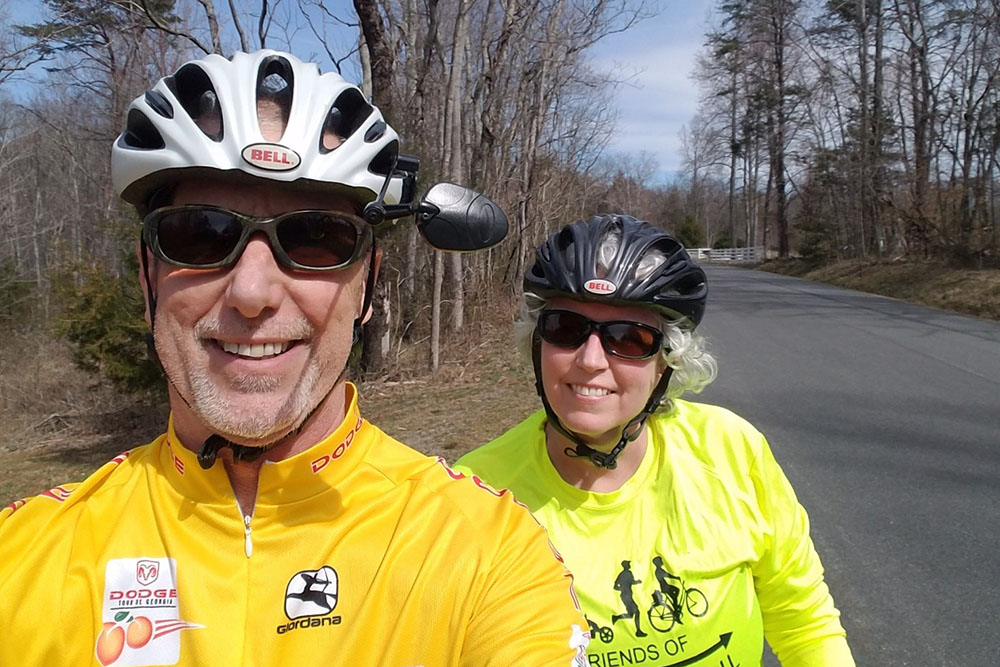 Beth Hundt on her bike, with husband Keith Crews