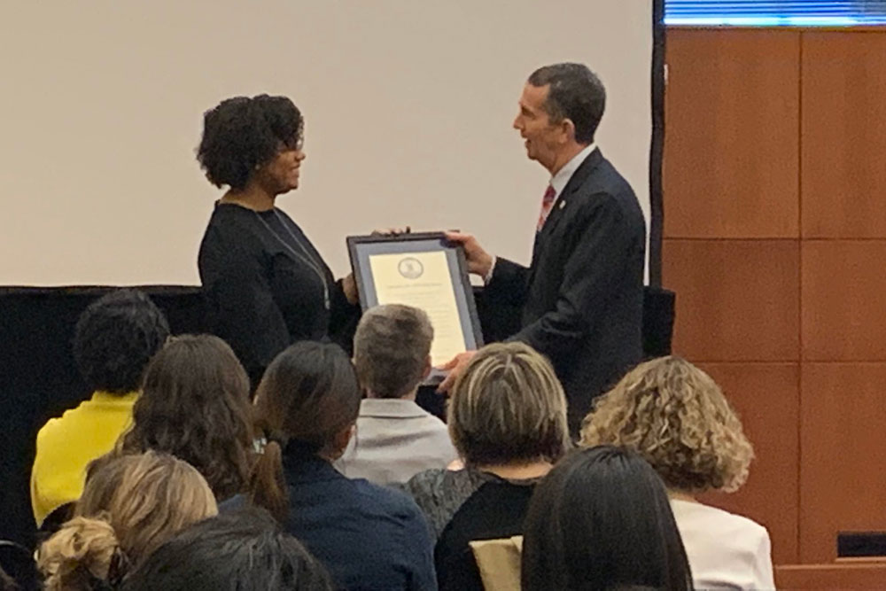 BSN student Natasha Coleman receives a plaque from Gov. Ralph Northam at VNA Lobby Day.
