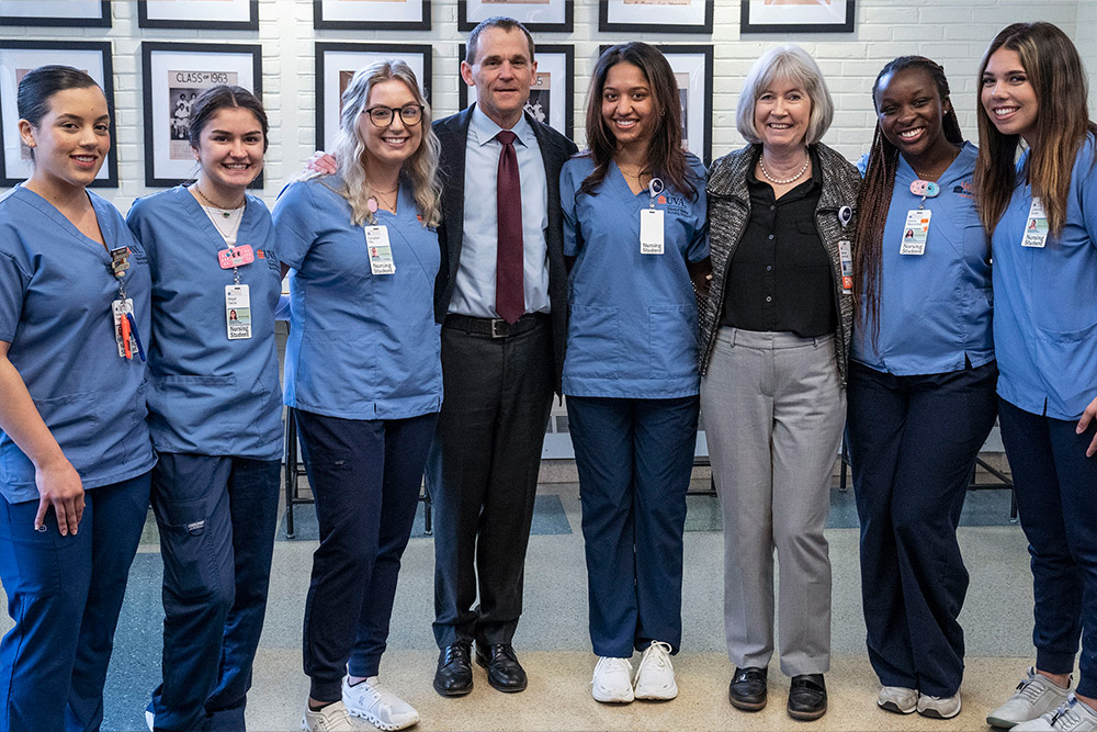 President Ryan and Dean Baernholdt pose with nursing students at the Starr Hill Pathways event.