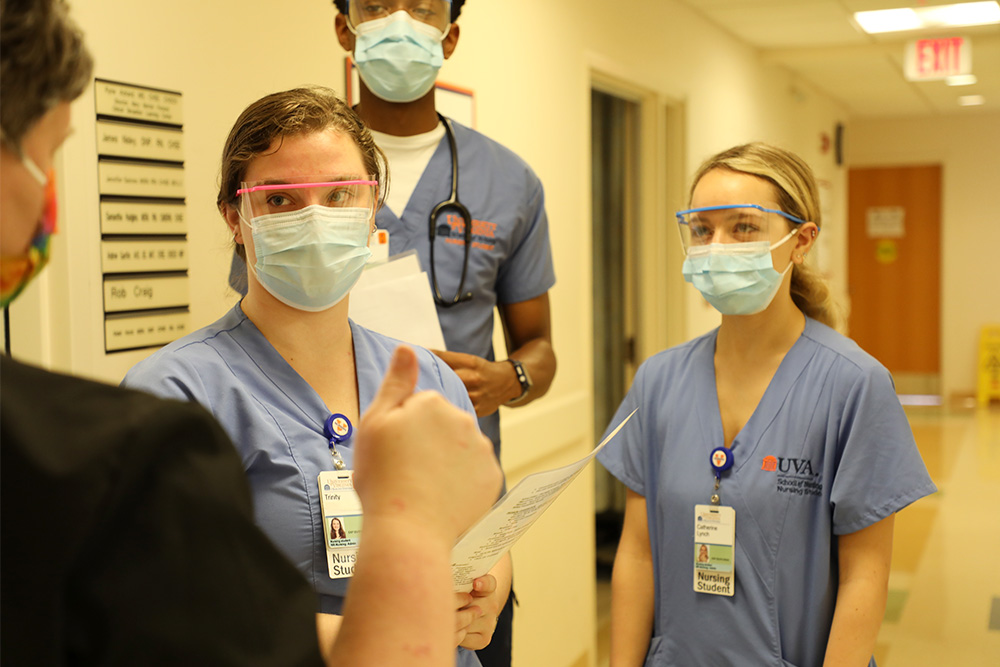 Nursing students prepare for obstetrics simulation.