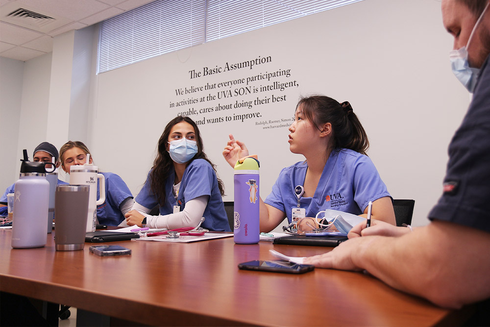 Nursing students in the CNL program debrief in the sim lab.