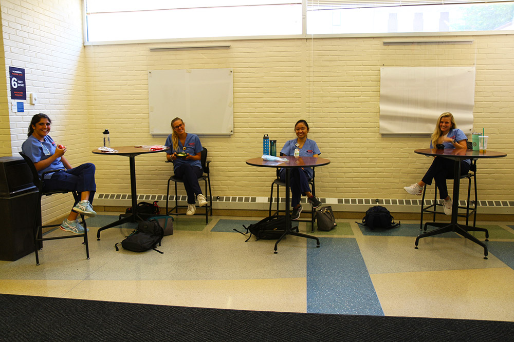 Four CNL students enjoy a socially distanced lunch in McLeod Hall.