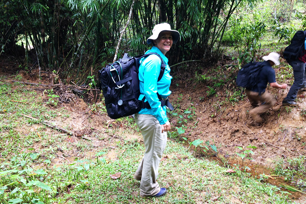 Terri Yost in Vietnam, crossing a stream in the jungle.